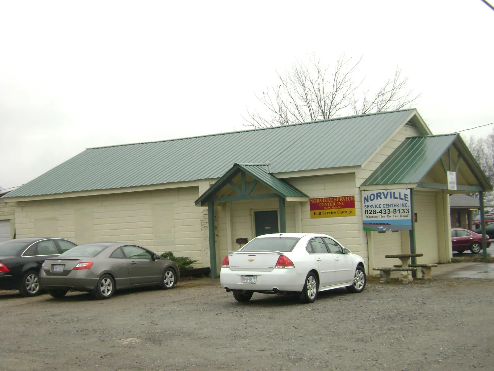 Green metal roof on a service garage with a covered entry in Cokeville