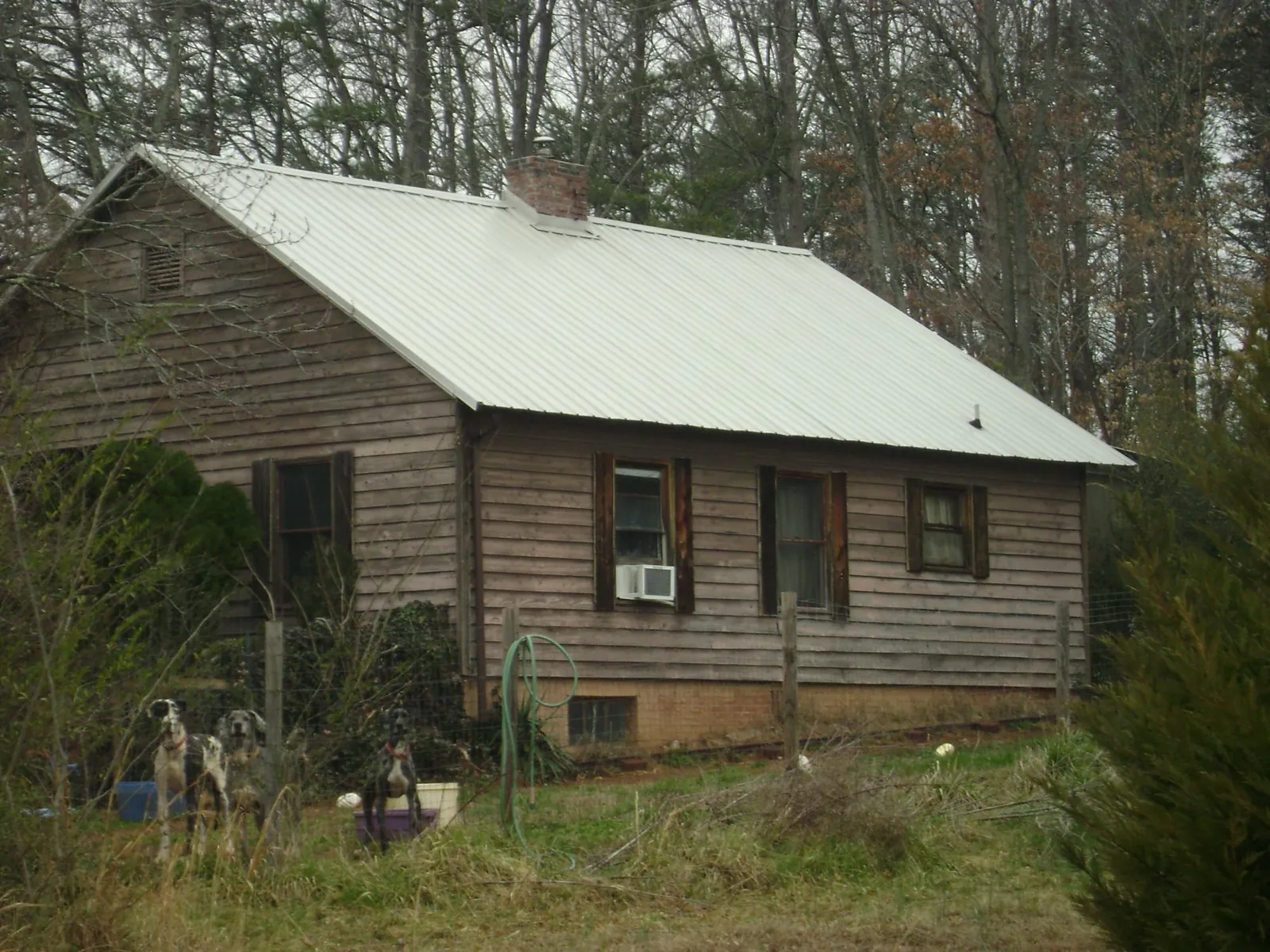 White metal roof on an old wood sided farmhouse, from a Metal Roof Installation job in Cokeville